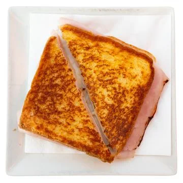 There is thin slice of soft and juicy ham between two slices of bread. 스톡 사진