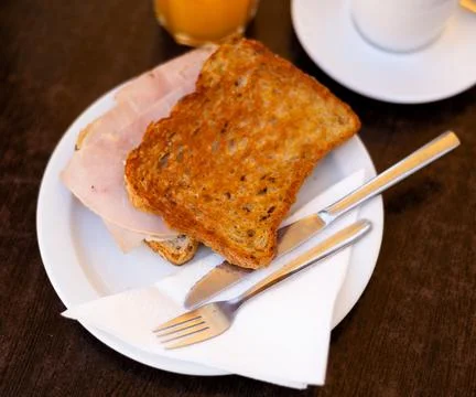 There is thin slice of soft and juicy ham between two slices of bread. Foto stock