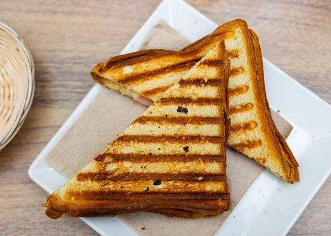 There is thin slice of soft and juicy ham between two slices of bread. Stock Photos