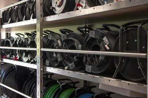 There was a room with racks of technical equipment, TV and cable reel Stockfoto's
