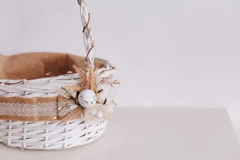 There is a white Eastern basket on the table. Stock Photos