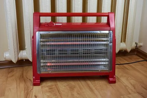 There is a working heating element next to the old cast-iron radiator. Foto stock