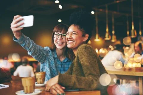 Theres always time to snap some selfies. two young friends taking a selfie Stock Photos