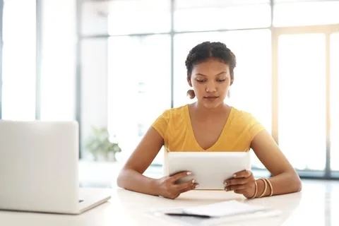 Theres an app to help complete any business task. a young businesswoman using a Stock Photos