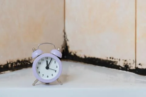 There's a clock in the shower stall. On the background of silicone putty, bla Stock Photos