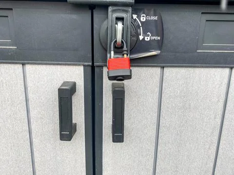 There's a metal lock with a code hanging on the door 写真素材