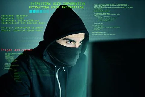 Theres no code he cant crack. a computer hacker using a laptop while standing Stock Photos