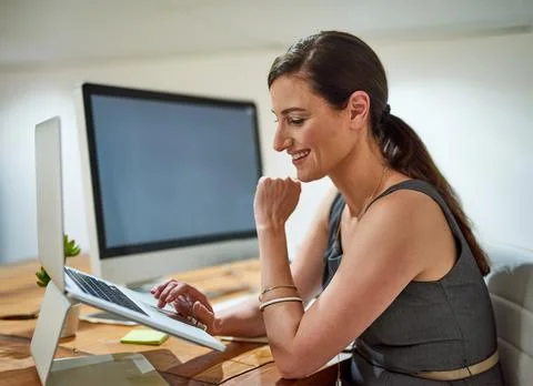 Theres no work task that she cant complete. a professional businesswoman using a Fotos de archivo