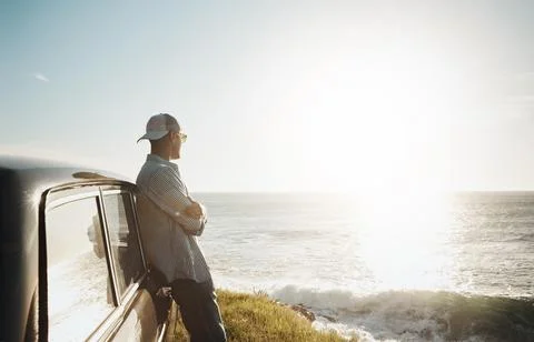 Theres something calming about a day at the coast. a young man on a road trip Stock Photos
