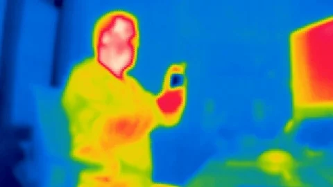 Thermal camera view, A human drinks from a can Stock Footage 105476627
