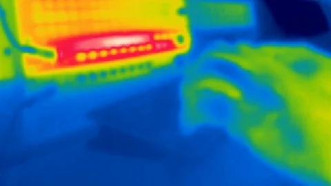 Thermal camera view, A person is working on a computer Stock Footage 105557647