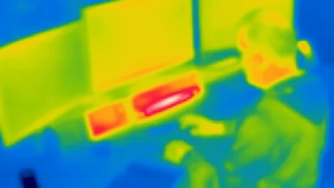 Thermal camera view, A person is working on a computer Stock Footage 105558148