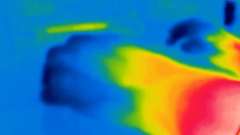 Thermal camera view, A person is working on a computer Stock Footage 105584075