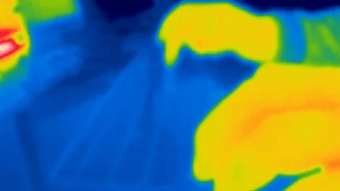 Thermal camera view, A person is working on a computer Video stock 105584295