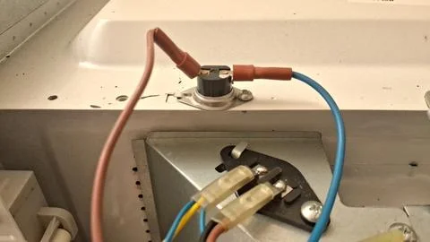 Thermal fuse component with electrical wires inside a microwave oven unit Stock Photos