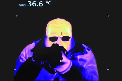 Thermal image of a man with the camera and temperature measurement Stock Photos