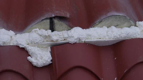 Thermal insulation material. Sealing or filling roof cracks with foam Stock Footage 321556656