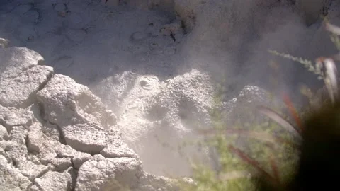 Thermal mud bubbles in slow-motion whilst hot steam passes Stock Footage 130227856