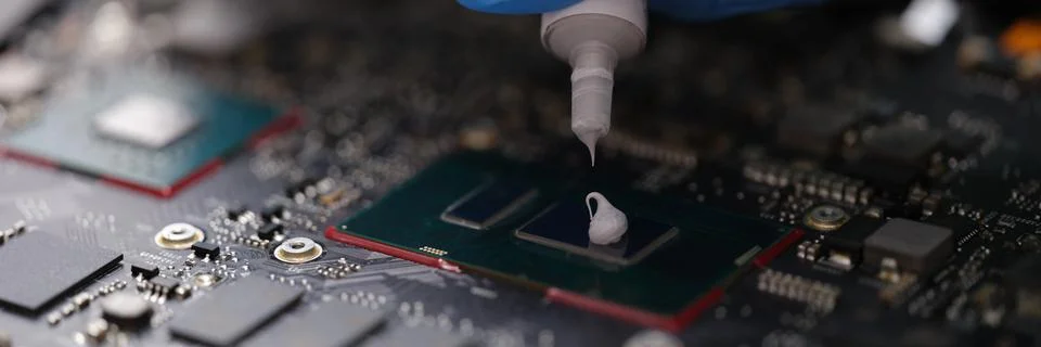 Thermal paste on computer processor chip closeup Stock Photos