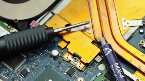 Thermal Paste Tube And Screwdriver On Laptop Board Stock Footage 345961618