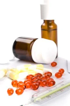 Thermometer and different pills Stock Photos