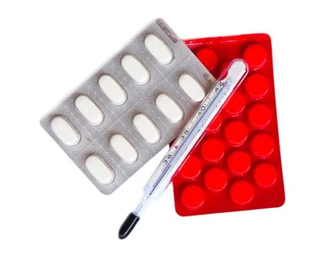 Thermometer and pills Stock Photos