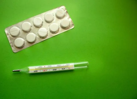 Thermometer and tablets Stock Photos