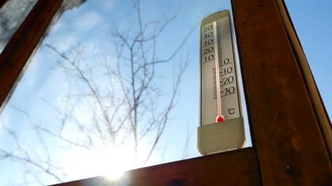 Thermometer in the background of the sun. Beautiful rays of the sun. above-zero Stock Footage 87871171