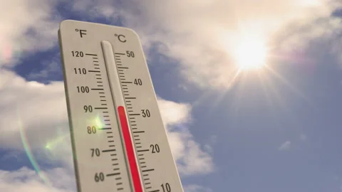 Thermometer on blue sky and shining sun Stock Footage 201402297
