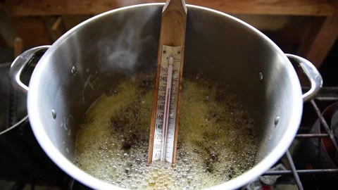 Thermometer in boiling maple syrup for cooking Stock Footage 167173137