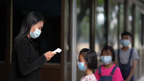 Thermometer checking temperature of body of children before to classroom Stock Footage 166097720