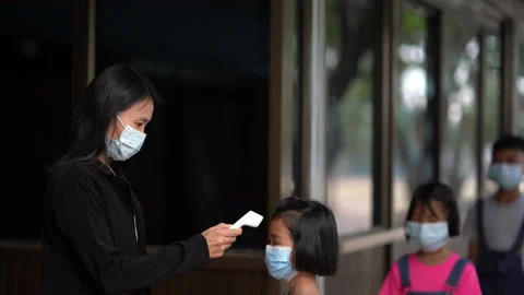 Thermometer checking temperature of body of children before to classroom 動画素材 166097812