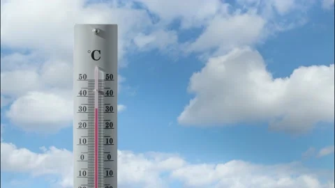 Thermometer with cloud timelaps in the background shows increasing temperature. Stock Footage 205526720