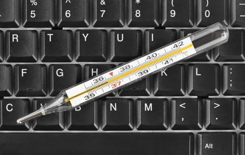 Thermometer on computer keyboard Thermometer on computer keyboard - concep... Stock Photos