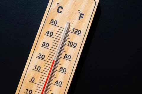 Thermometer on dark surface. Stock Photos