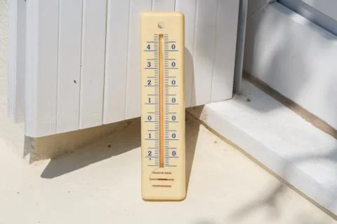 Thermometer on the edge of a window Stock Photos