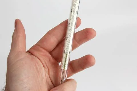 Thermometer in hand closeup Stock Photos