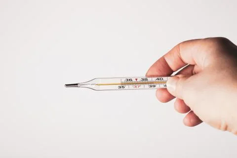 Thermometer in hand on white background. Foto stock