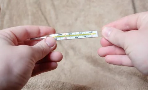 A thermometer in the hands Stock Photos