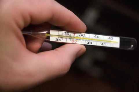 A thermometer in the hands Stock Photos