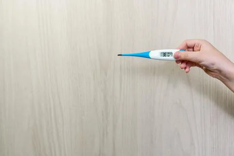 The thermometer in his hand. pointer. Stock Photos