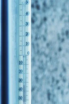 Thermometer in home window in cold winter day Stock Photos