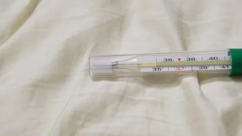 Thermometer indicating normal body temperature on bed Stock Footage 336126339