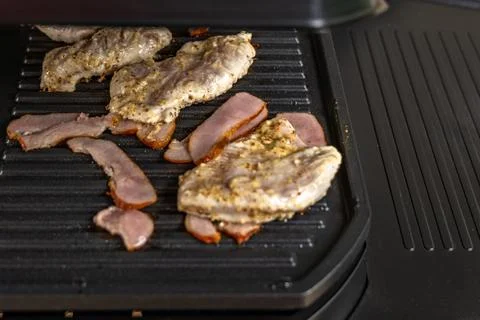 The thermometer installed on the electric grill indicates high temperature,.. Stock Photos