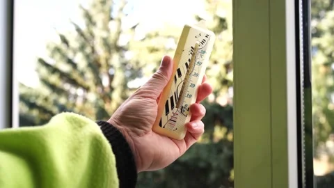 Thermometer in a man's hand by the window Stock Footage 171766037