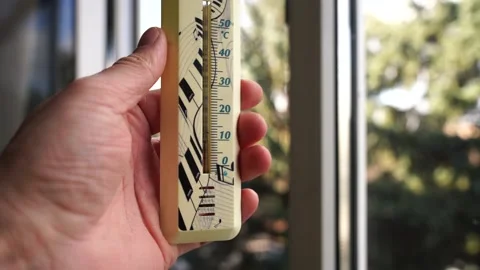 Thermometer in a man's hand by the window Stock Footage 171766335