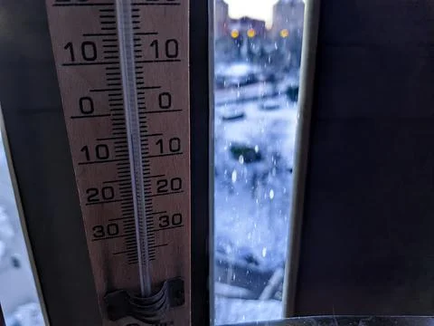 Thermometer marking subzero in snow Stock Photos