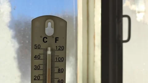 Thermometer for measuring temperature in hand against the background of an old Stock Footage 326734976