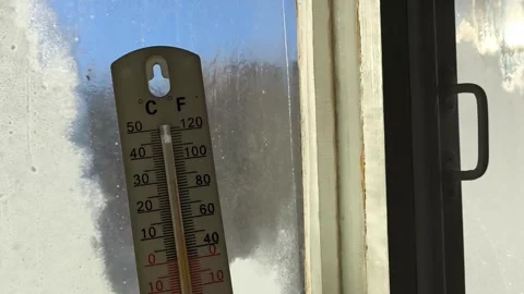 Thermometer for measuring temperature in hand against the background of an old Stock Footage 326735011