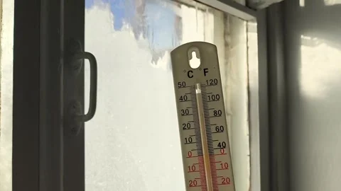 Thermometer for measuring temperature in hand against the background of an old Stock Footage 326735041